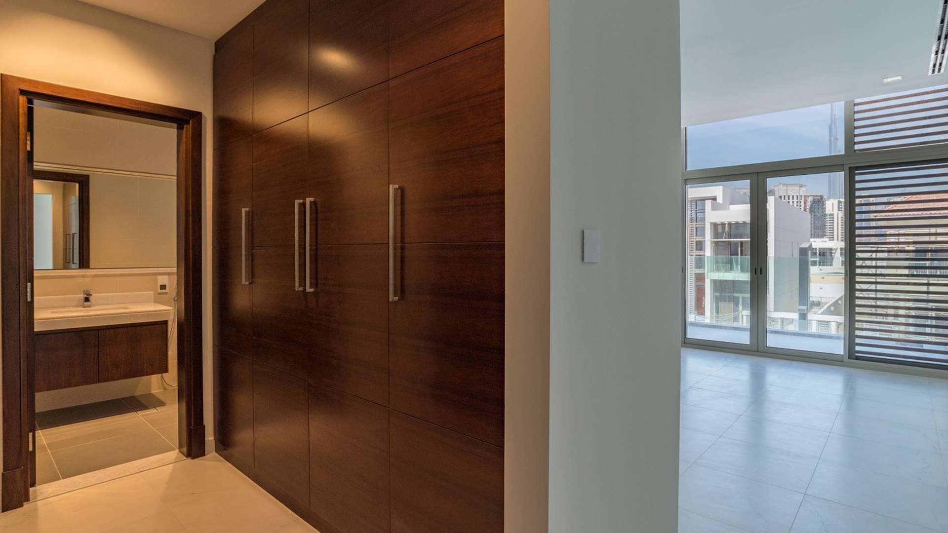 Spacious open-plan living area in luxury villa, District One, Dubai, with modern kitchen