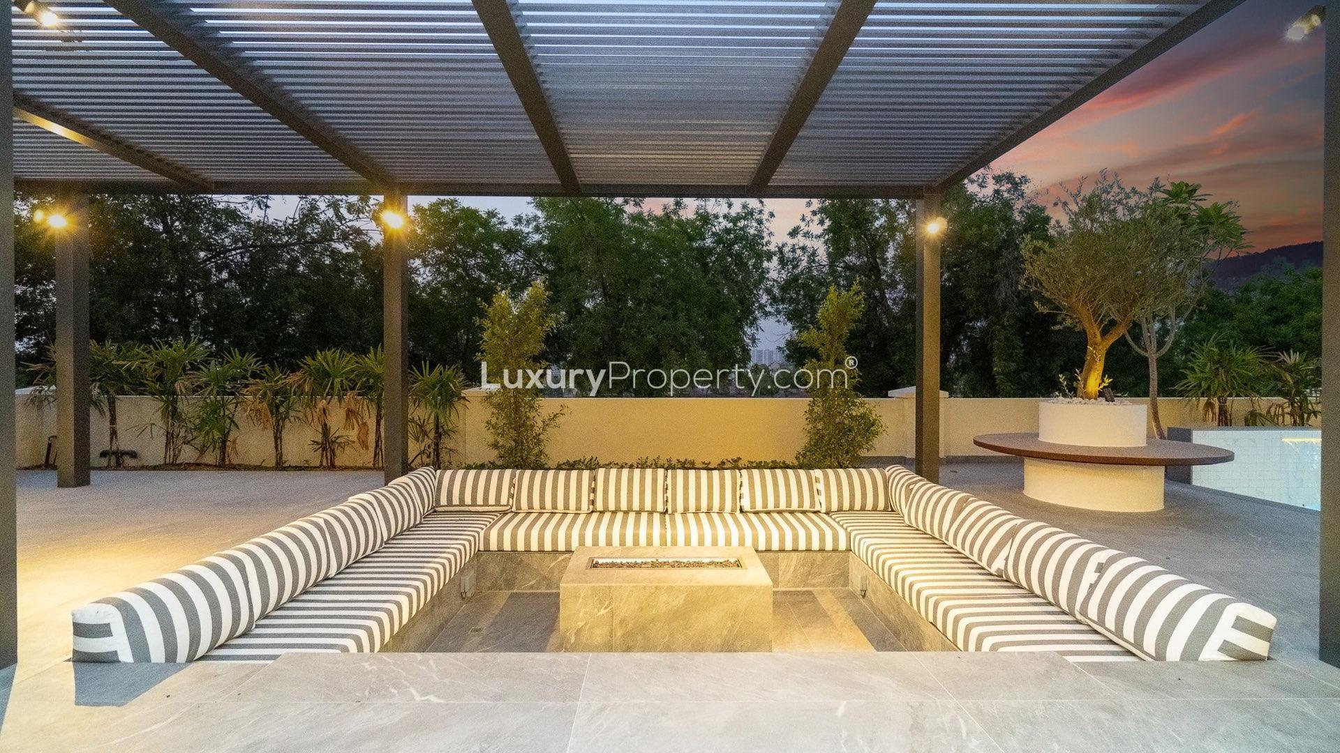 "Luxurious patio with pool at upgraded villa in Jumeirah Golf Estates, Earth community.",Modern open-plan living area in fully upgraded 6-bedroom villa, Jumeirah Golf Estates, Earth