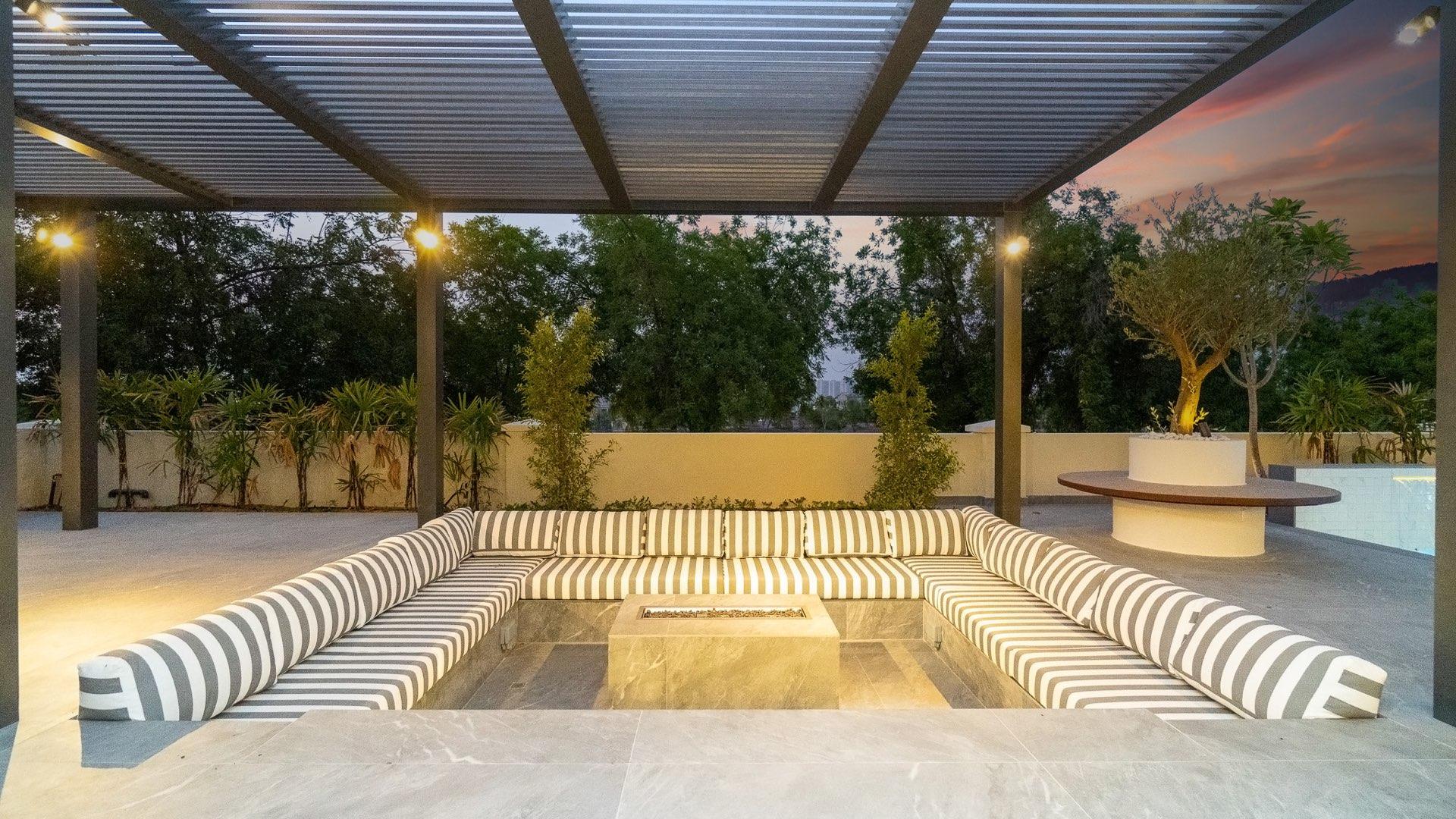 "Luxurious patio with pool at upgraded villa in Jumeirah Golf Estates, Earth community.",Modern open-plan living area in fully upgraded 6-bedroom villa, Jumeirah Golf Estates, Earth
