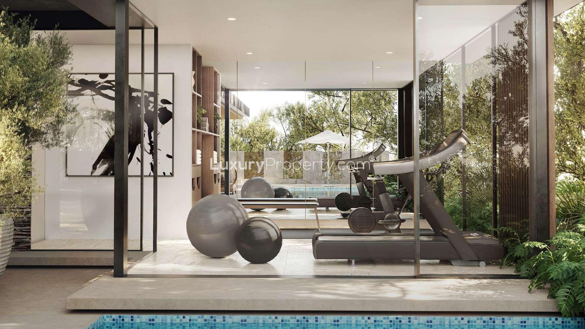 Peaceful park setting in Tilal Al Ghaf's Elysian Mansions community, lush greenery and pathways