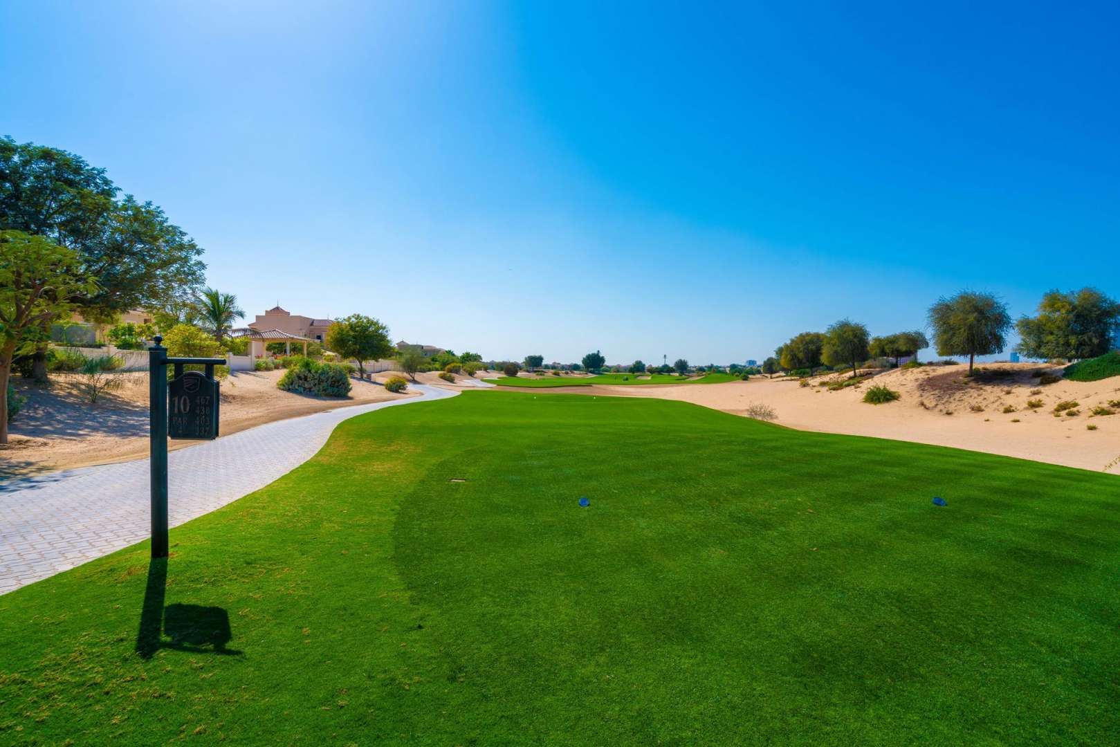Bright living room with large arched window in Esmeralda villa, Victory Heights, Dubai