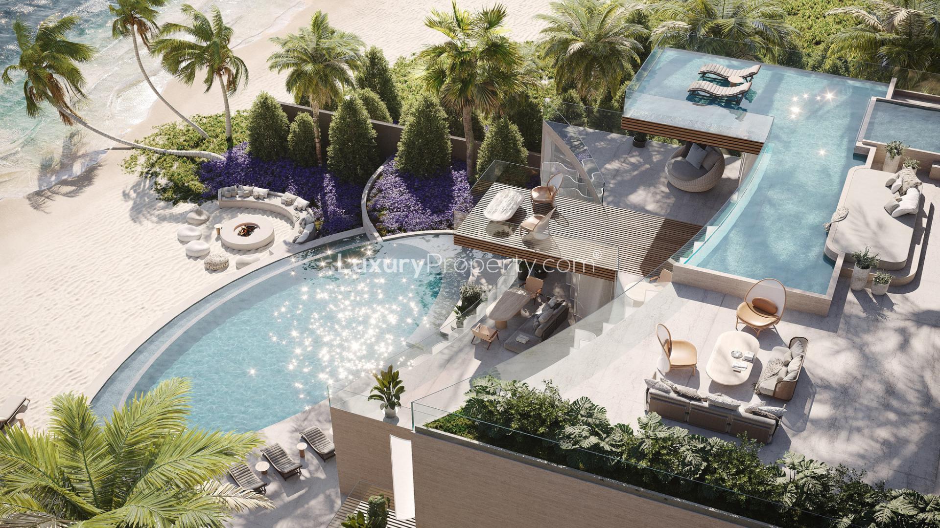 Luxurious beachfront villa with infinity pool and palm trees on Zuha Island