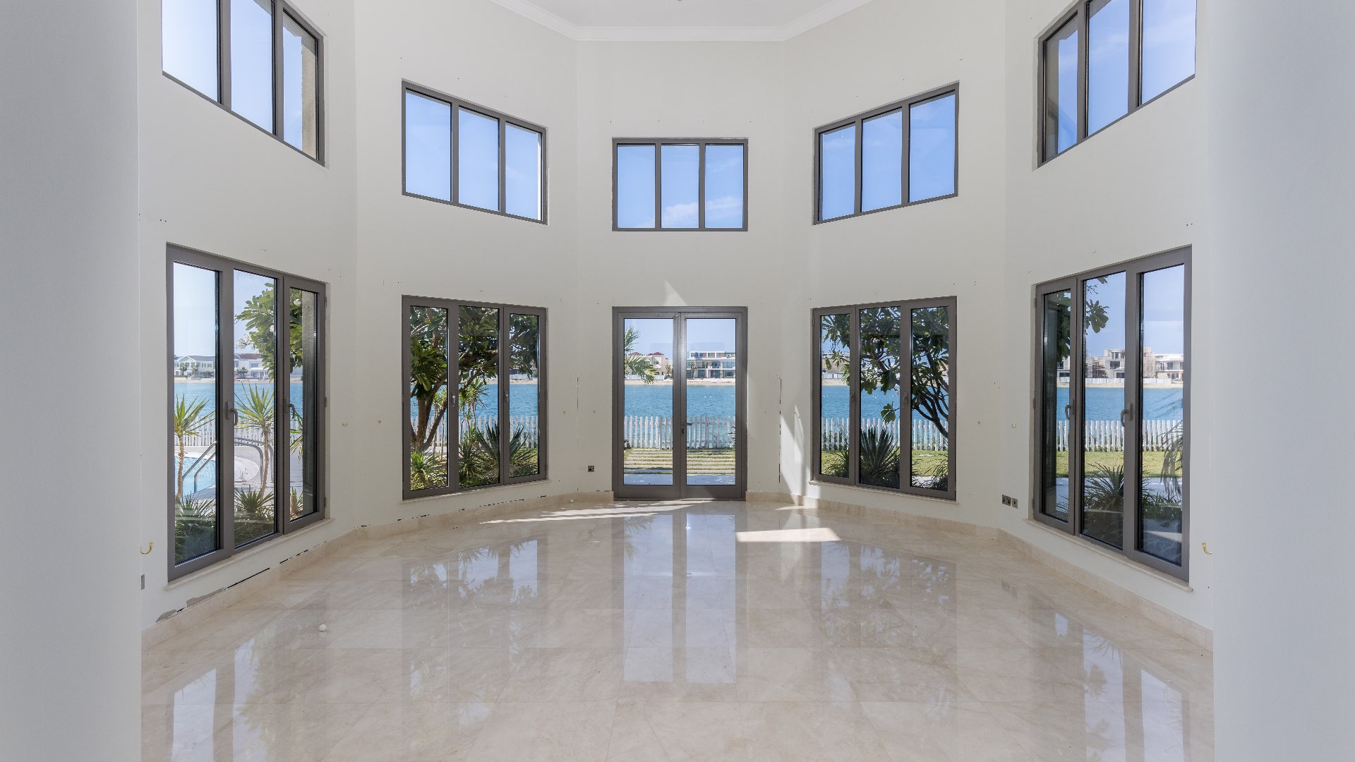 Bright interior of six-bedroom villa in Palm Jumeirah with marble flooring and large windows