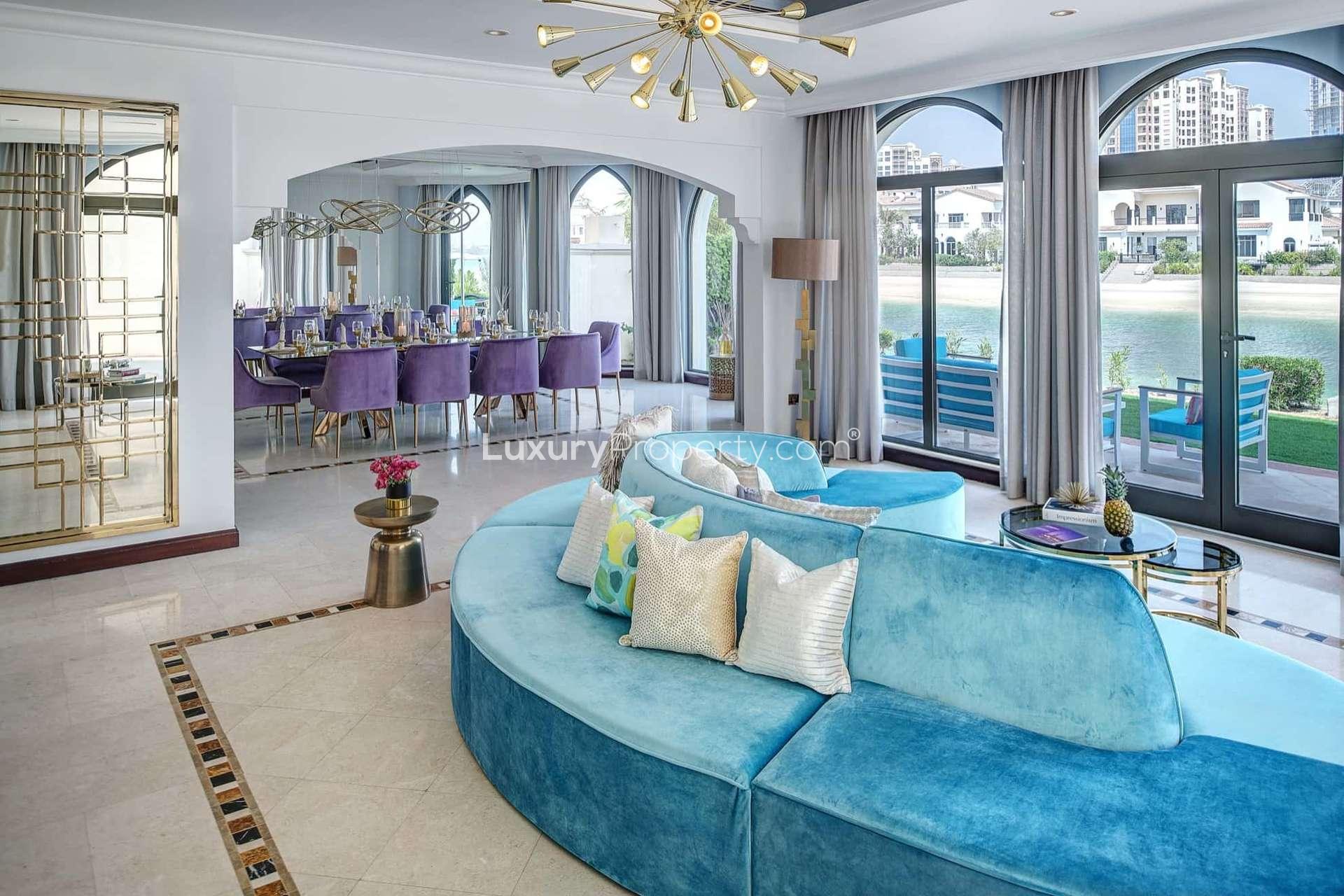 Elegant dining room in luxurious Mediterranean villa, Palm Jumeirah, with purple chairs and glass table