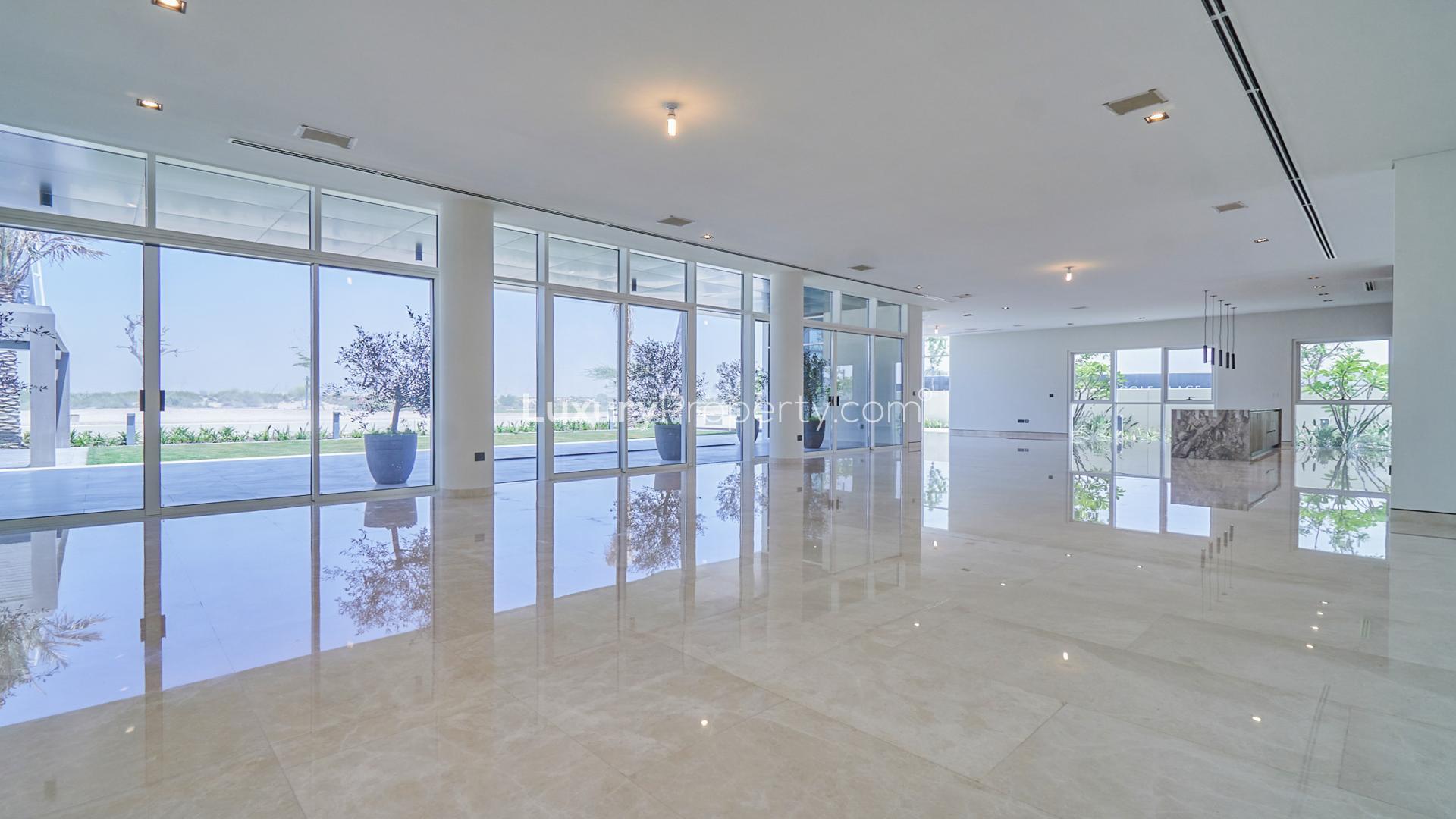 Modern villa exterior in Dubai Hills Estate, featuring spacious garden and large windows