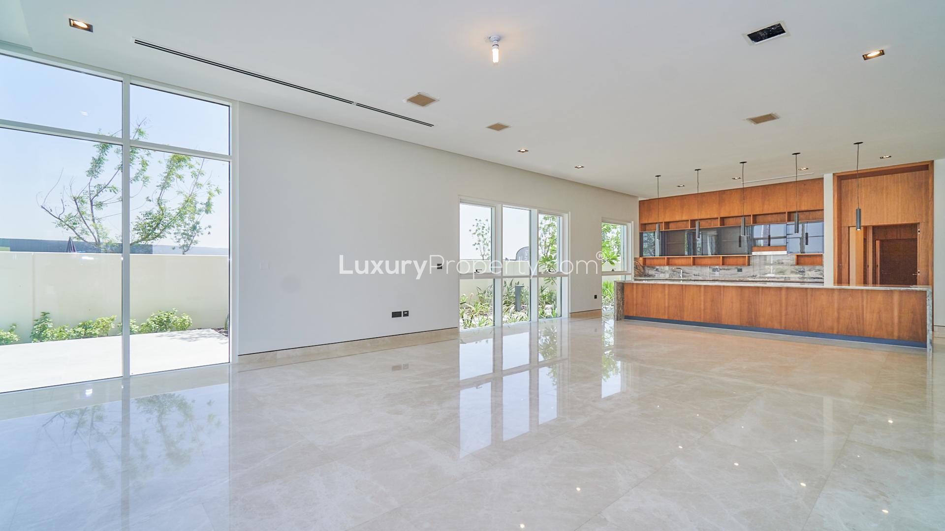 Spacious villa interior with floor-to-ceiling windows, overlooking golf course in Dubai Hills Estate