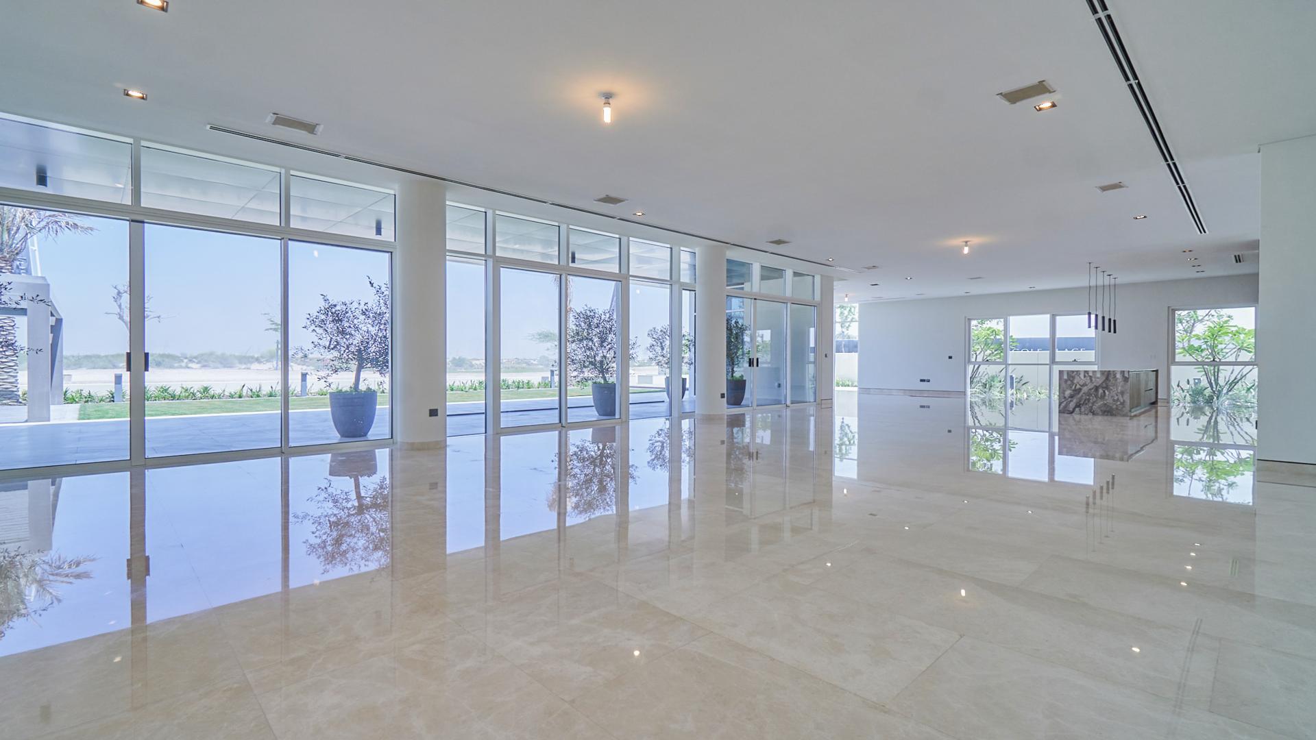 Spacious villa interior with floor-to-ceiling windows, golf course view, Dubai Hills Estate