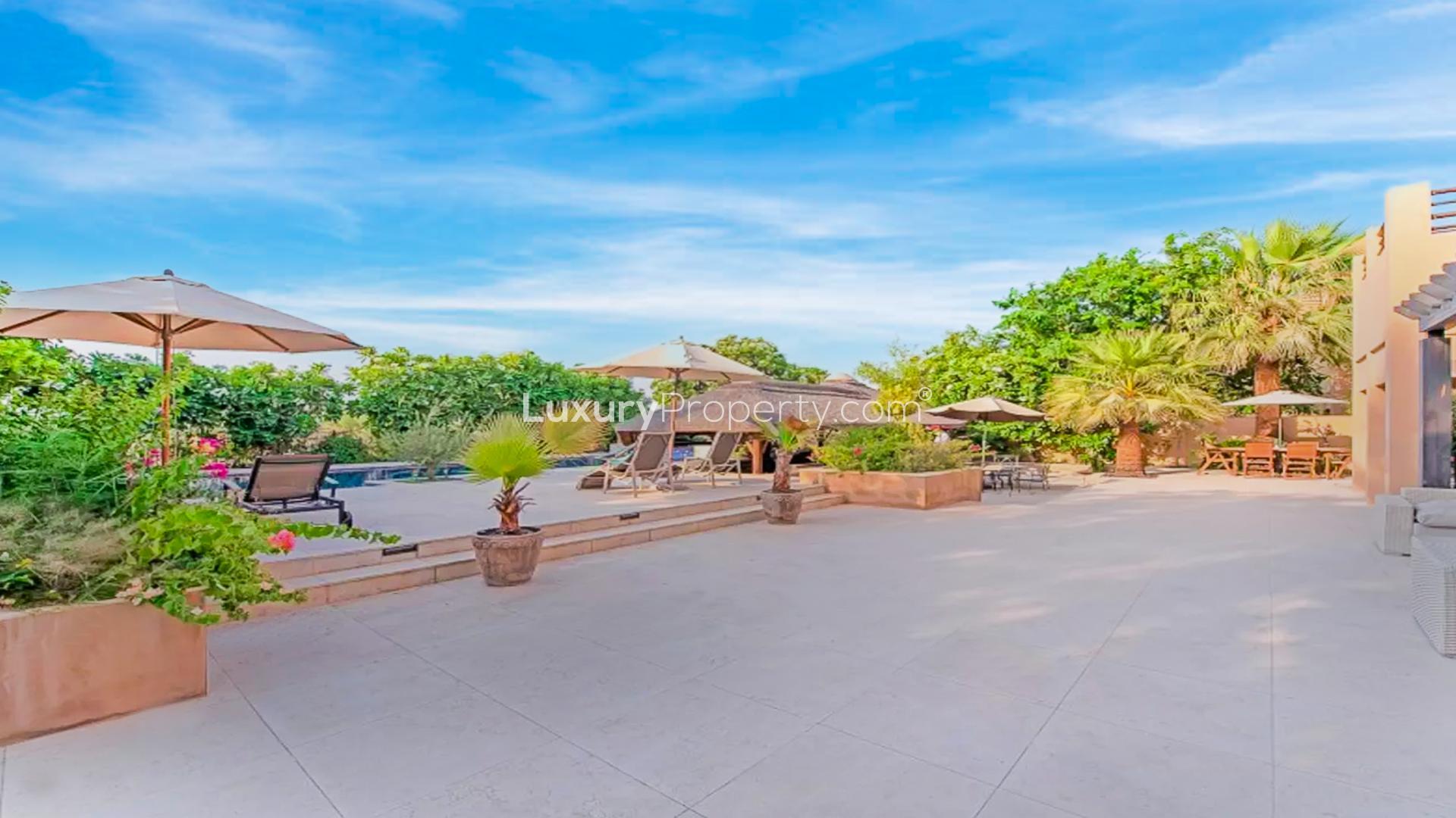 Luxury villa in Hattan, Dubai with private pool, surrounded by lush greenery