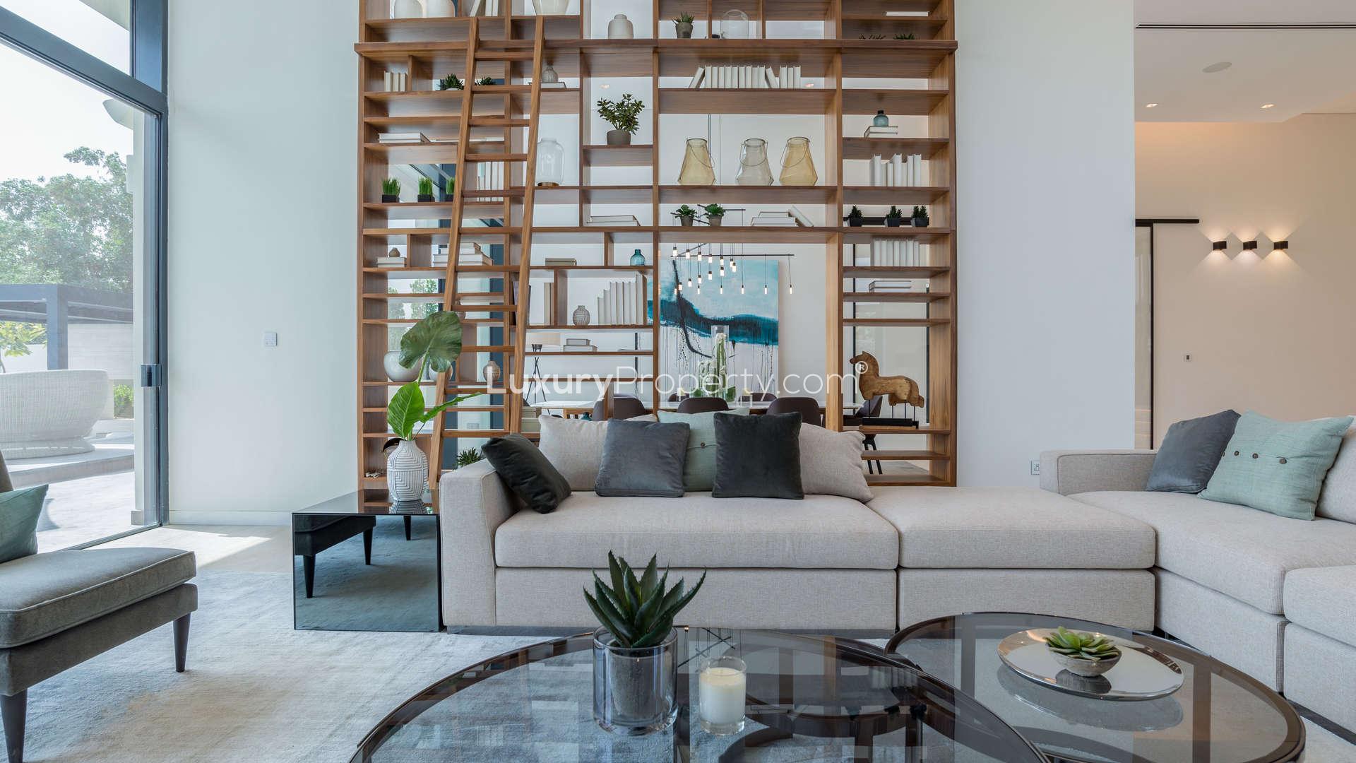 Luxurious living room in Hillside Villa, Jumeirah Golf Estates, with modern decor and pool view