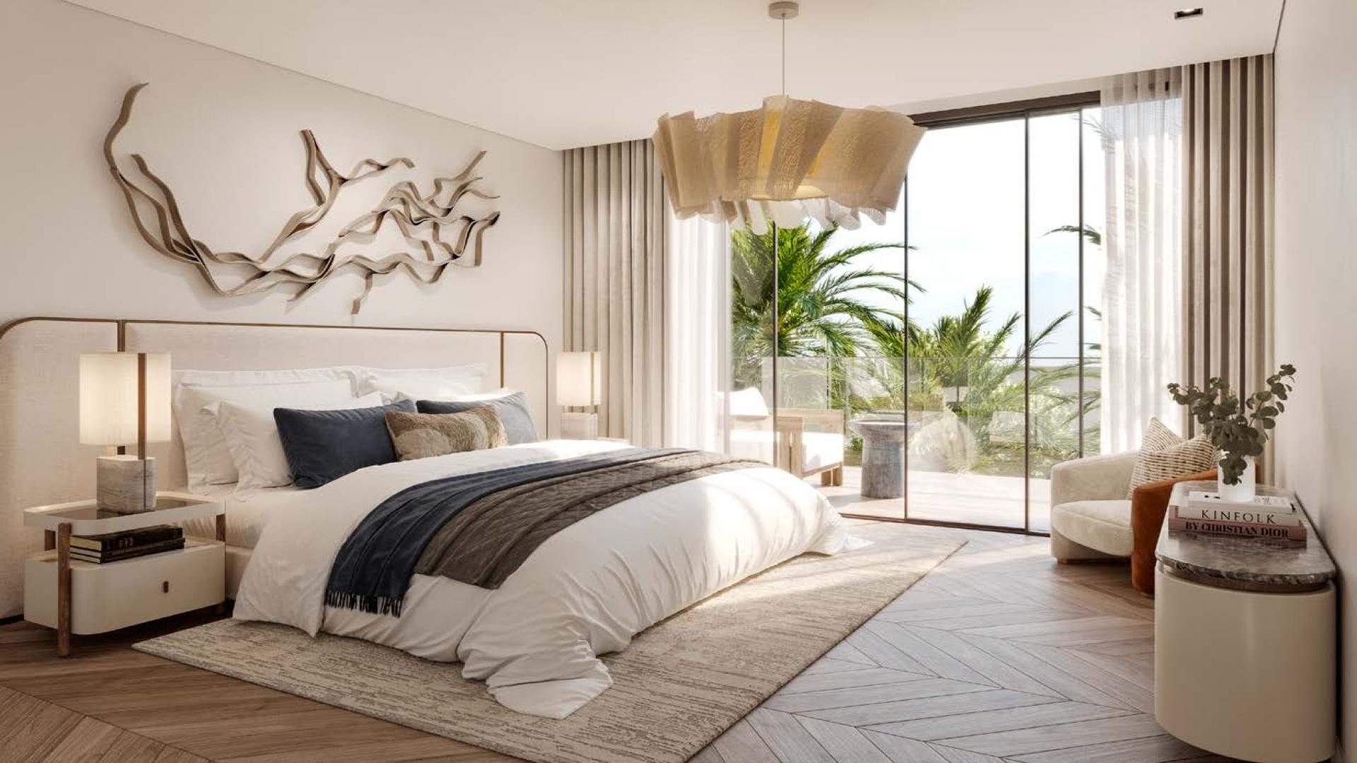 Luxurious bedroom with modern decor and balcony view in Nad Al Sheba villa for sale