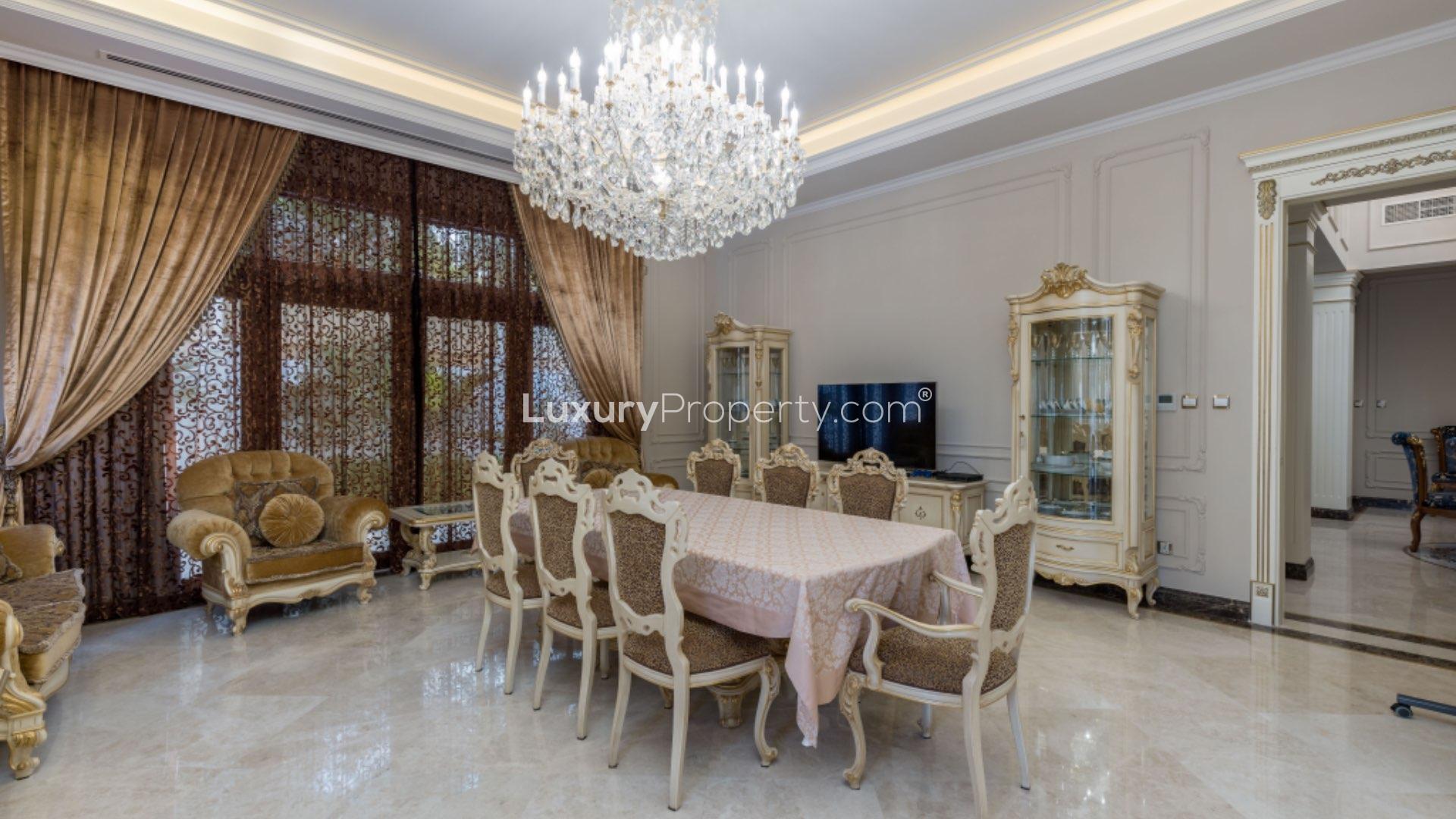 Elegant dining room in upgraded Al Barari villa with chandelier and luxurious decor