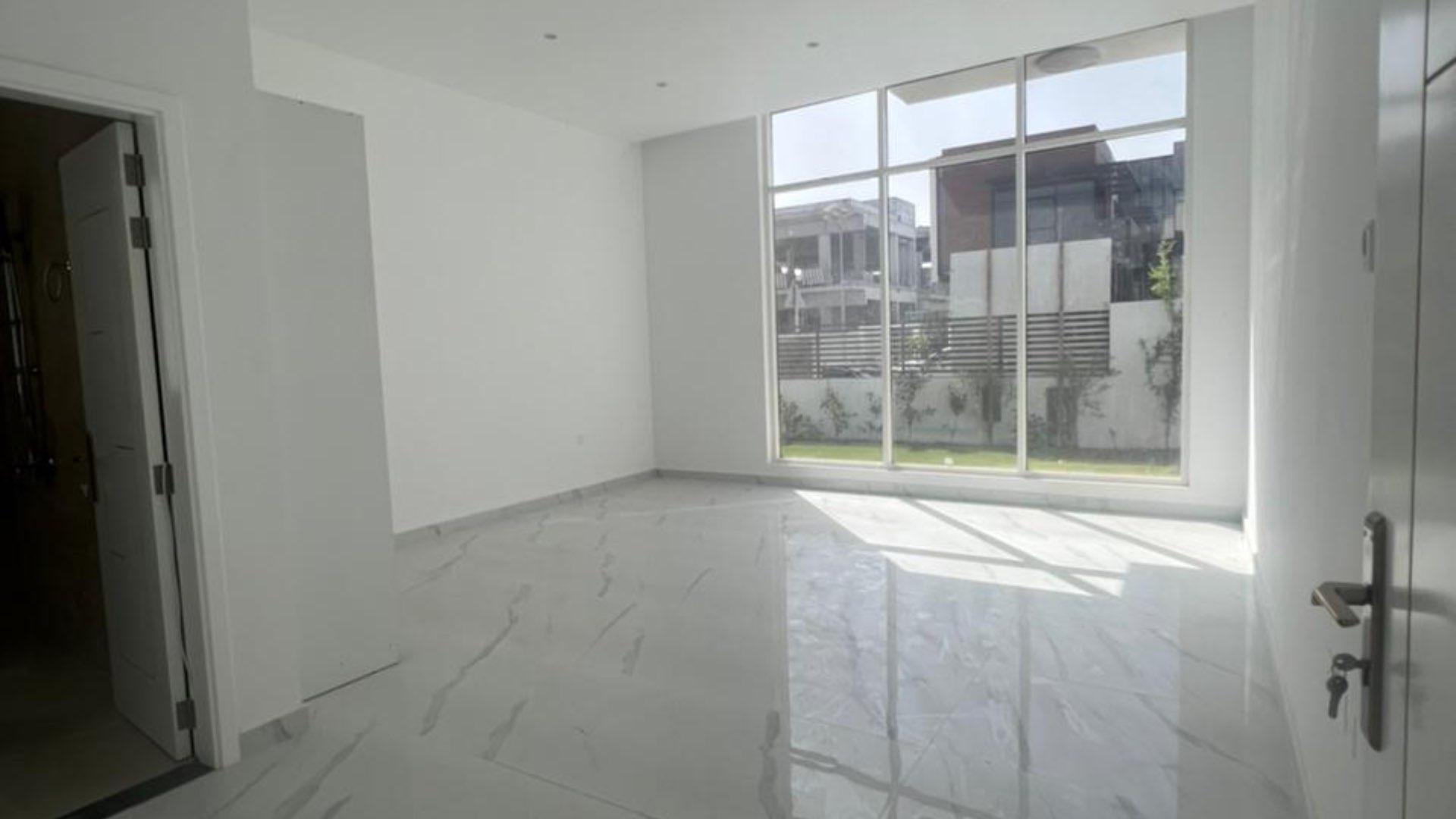 Modern staircase in Jumeirah Park custom villa for sale, featuring sleek glass railings