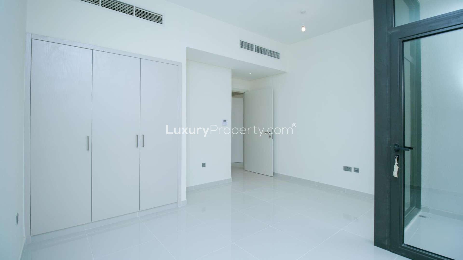 Spacious living area in six-bedroom villa, Juniper, Damac Hills 2, large windows, bright interior