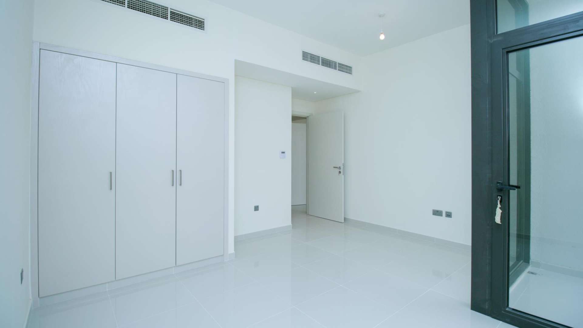 Spacious living area in six-bedroom villa, Juniper, Damac Hills 2, large windows, bright interior