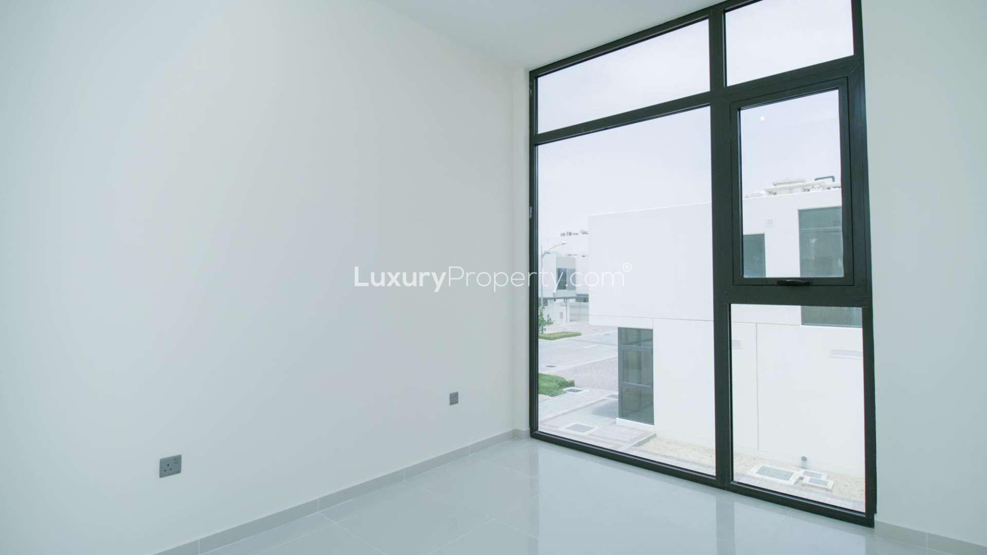 Bright bedroom with built-in wardrobe in six-bedroom villa, Juniper, Damac Hills 2, Akoya