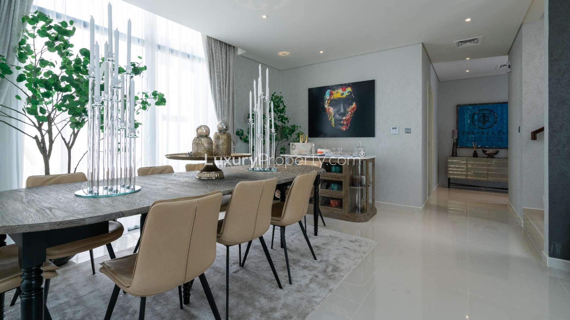 Dining area in six-bedroom villa, elegant decor, large windows, Juniper Cluster, Akoya community