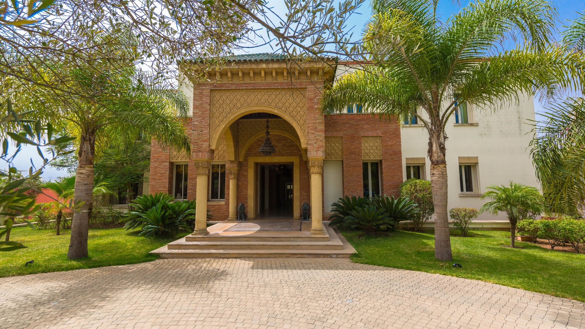 Grand entrance of Villa Raga in Casablanca, showcasing elegant arches and detailed architecture