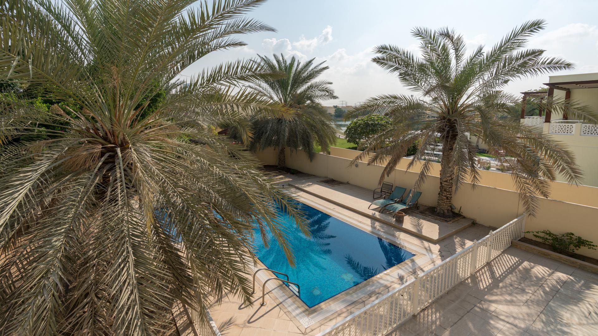 Luxurious 6-bedroom villa with pool, lush garden, and palm trees in Meadows 9