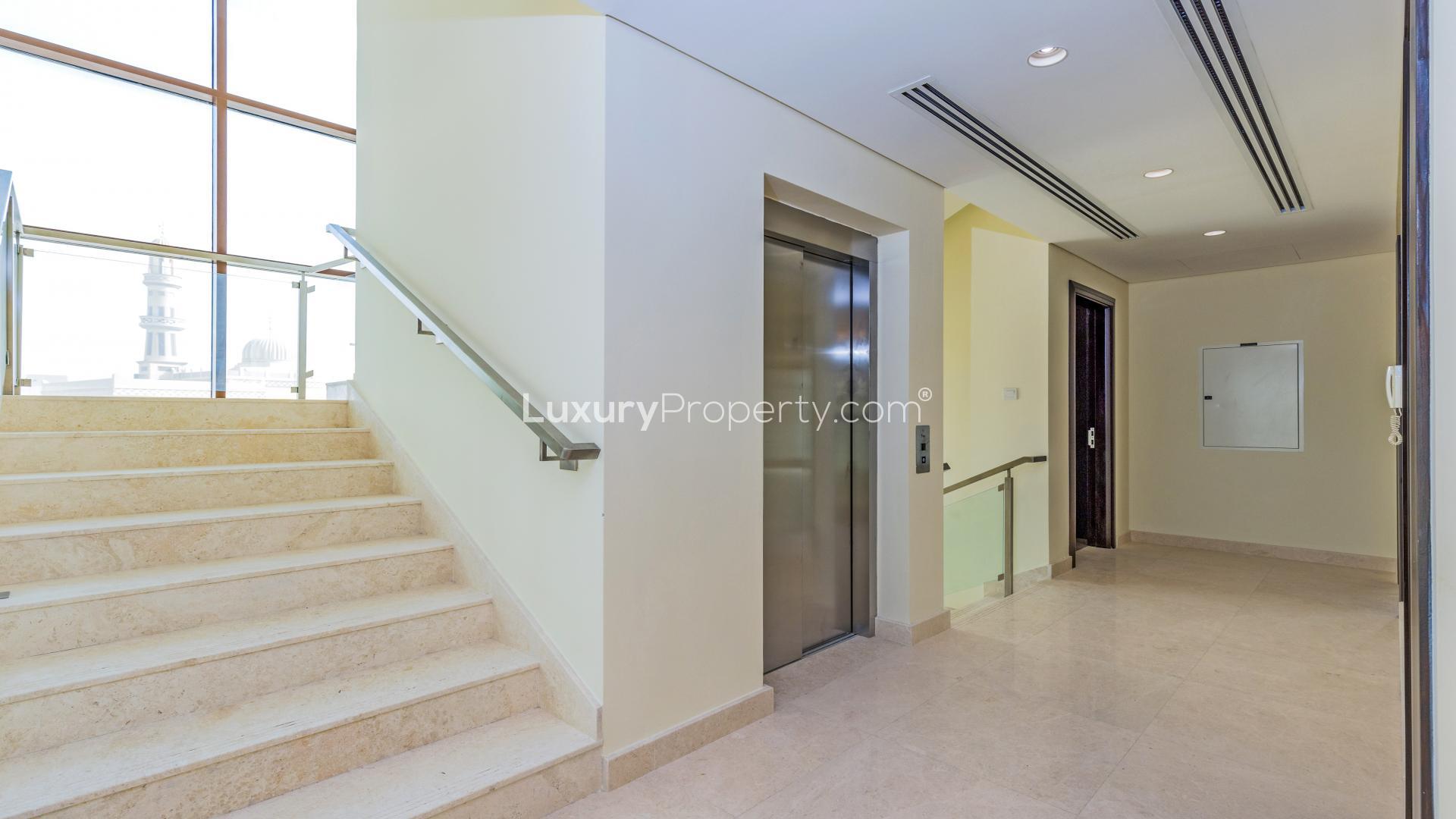 Spacious living area with large windows in Meydan 6-bedroom villa for sale