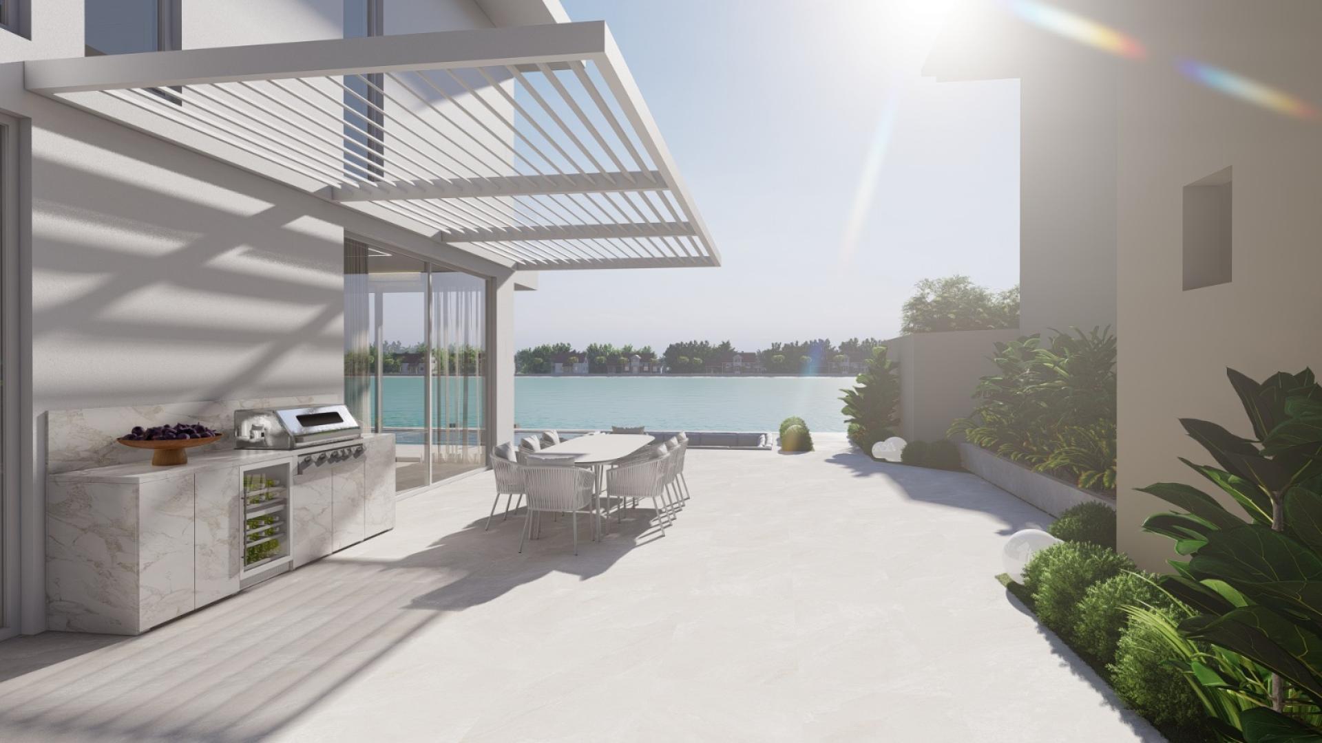 Renovated villa exterior with modern design in Palm Jumeirah, featuring landscaped garden and car