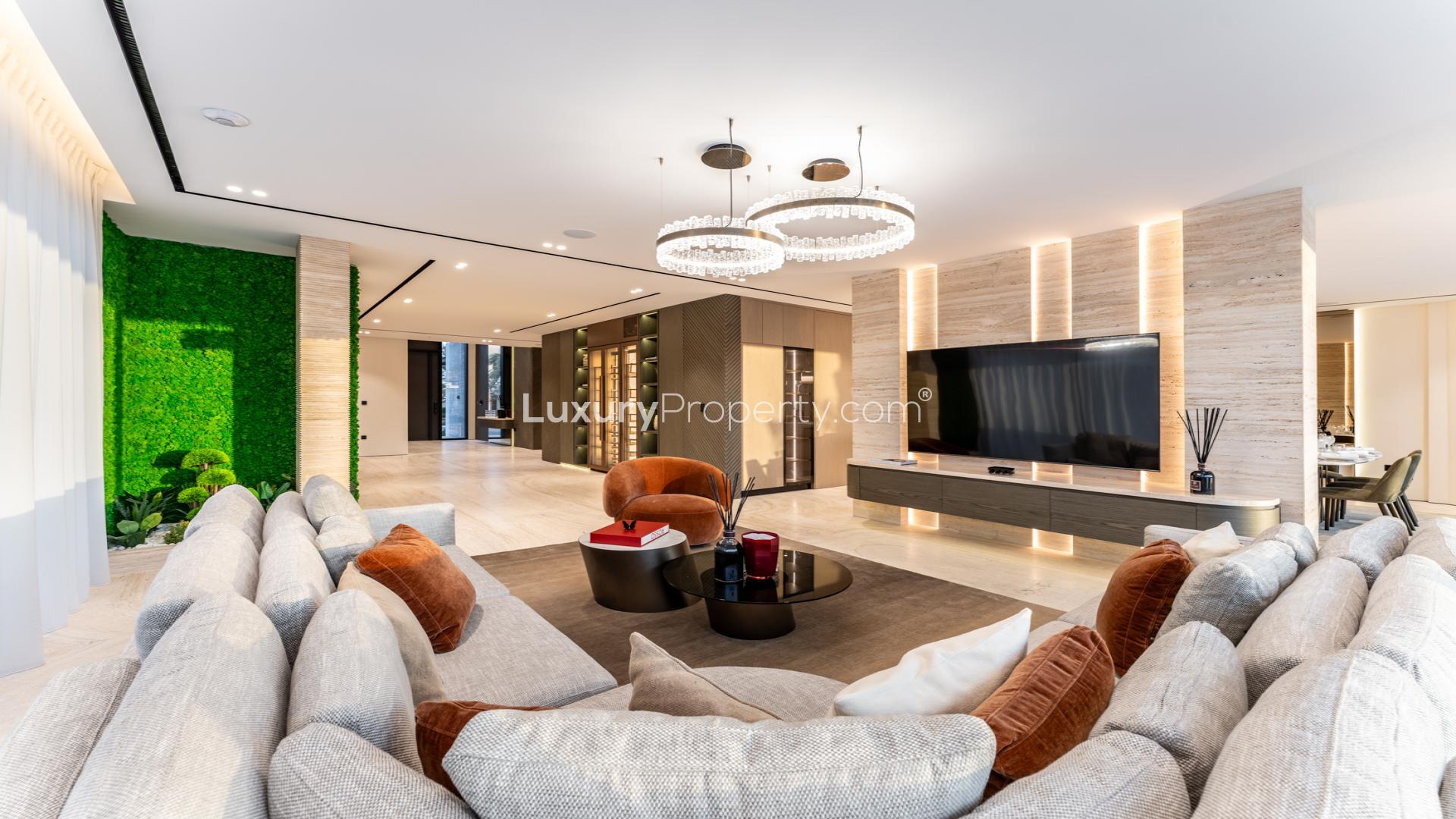 Luxurious living room in Palm Jumeirah villa with modern decor and large TV display