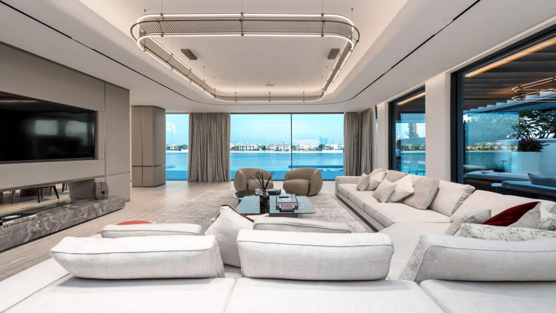 Modern dining area with elegant decor and waterfront views, Palm Jumeirah villa for sale