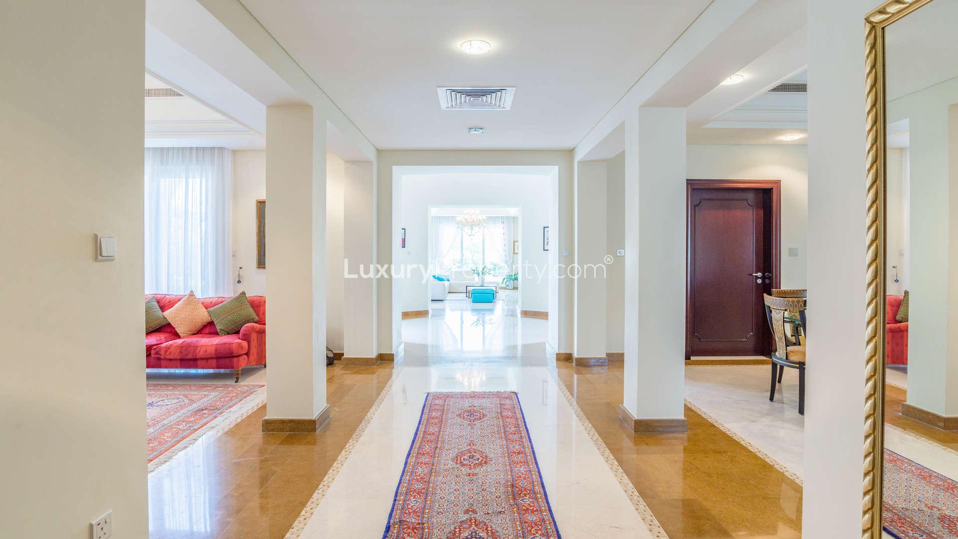 Luxurious bedroom with elegant wooden furniture in Victory Heights villa, Dubai Sports City