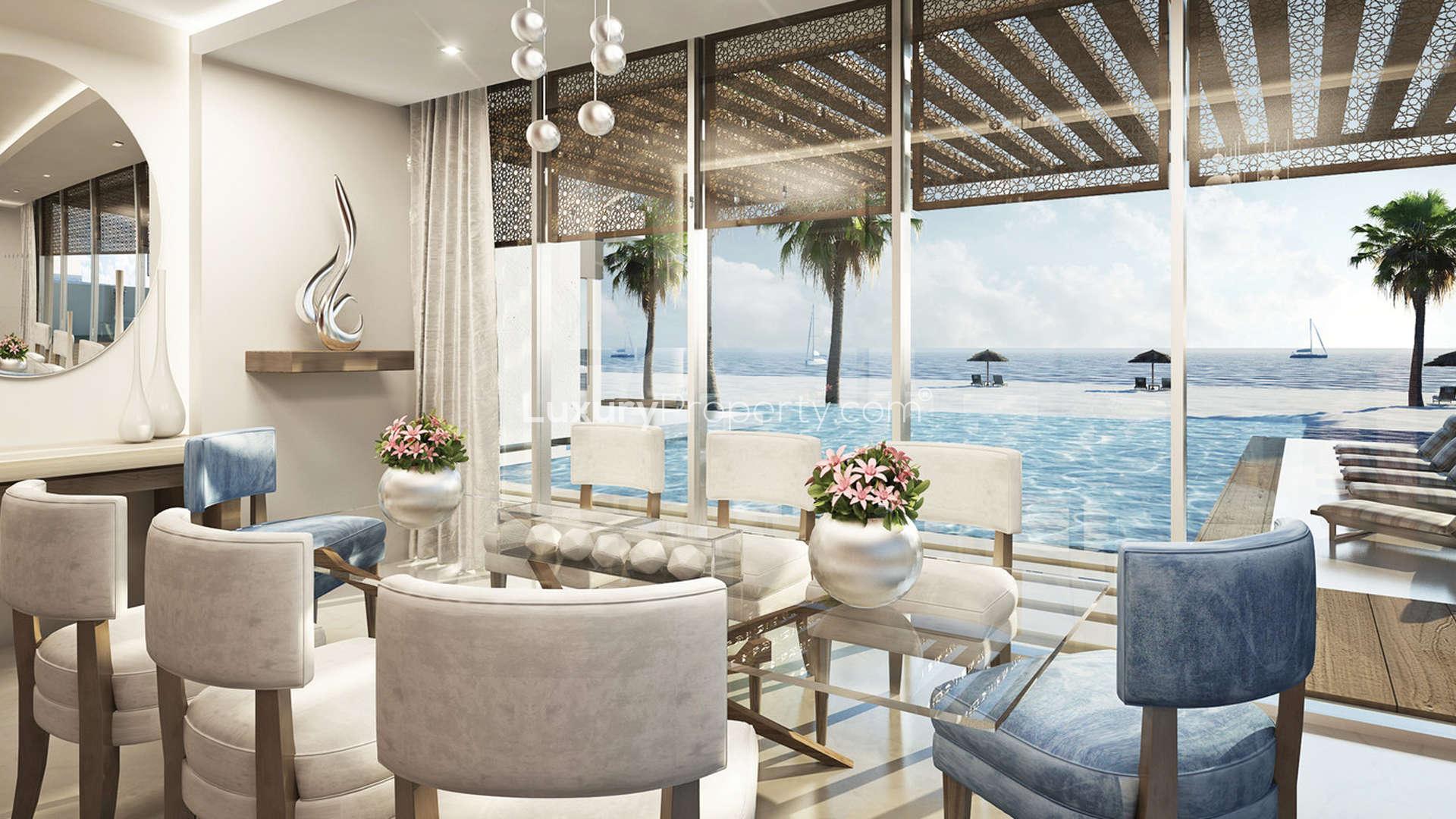 Luxurious living room in six-bedroom beach villa, Saadiyat Island, with modern decor and pool view