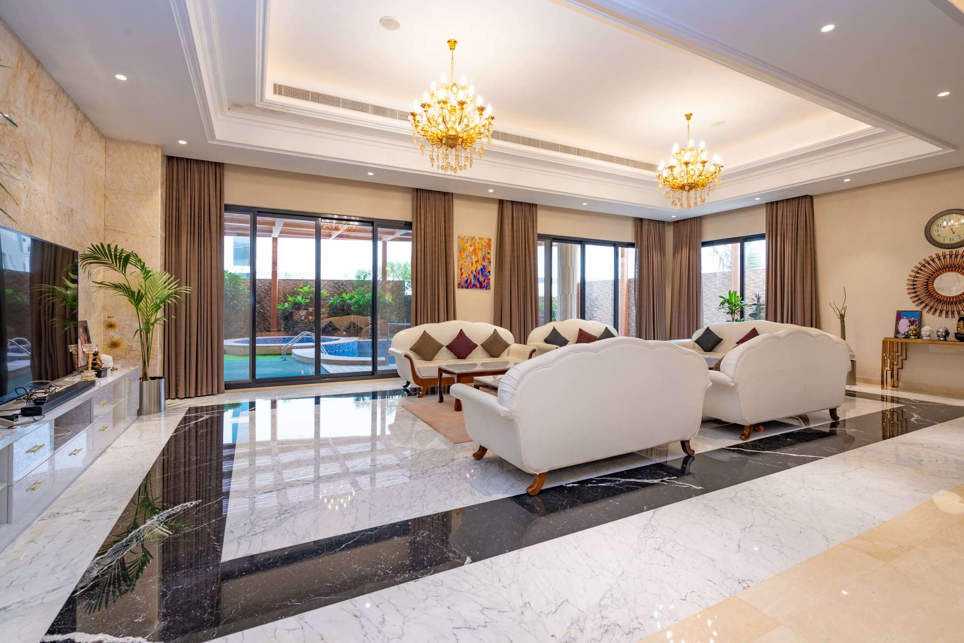 Covered patio with pool and seating area in Pearl Jumeirah villa, Jumeirah community