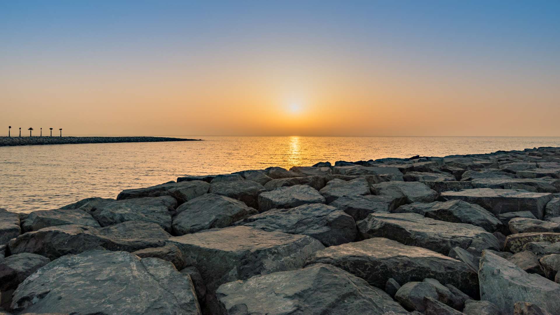 Sunset view over waterfront rocks at Pearl Jumeirah, near luxury villa for sale