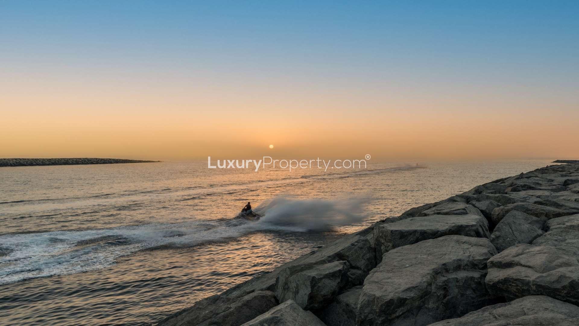 Sunset view over rocky waterfront at Pearl Jumeirah, near luxury villa for sale