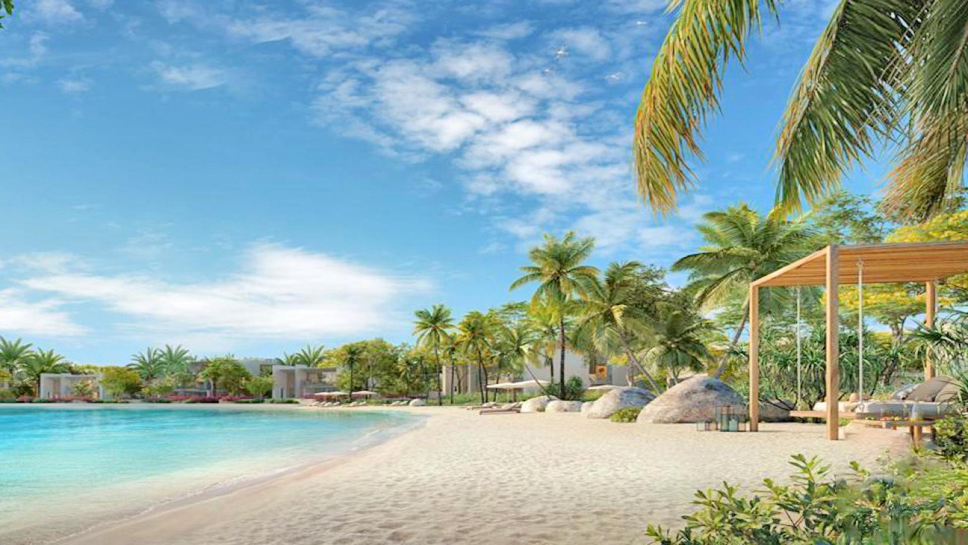 Tilal Al Ghaf Serenity Mansions villa beachfront view with palm trees and azure waters