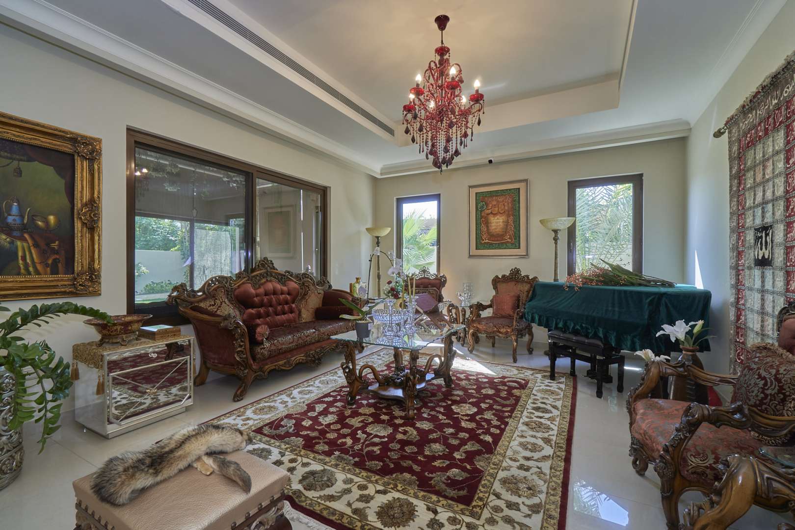 Bright sunroom in Arabian Ranches 2 villa, featuring garden views and cozy seating area
