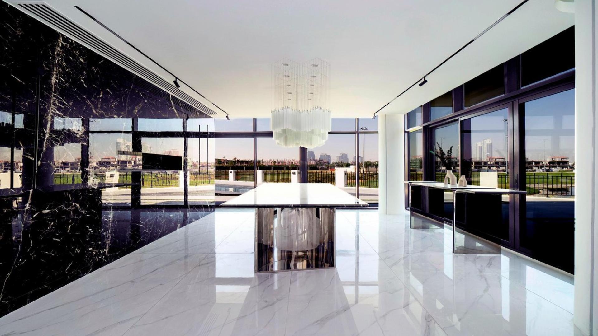 Modern living room in Damac Hills villa with elegant furniture and golf course views