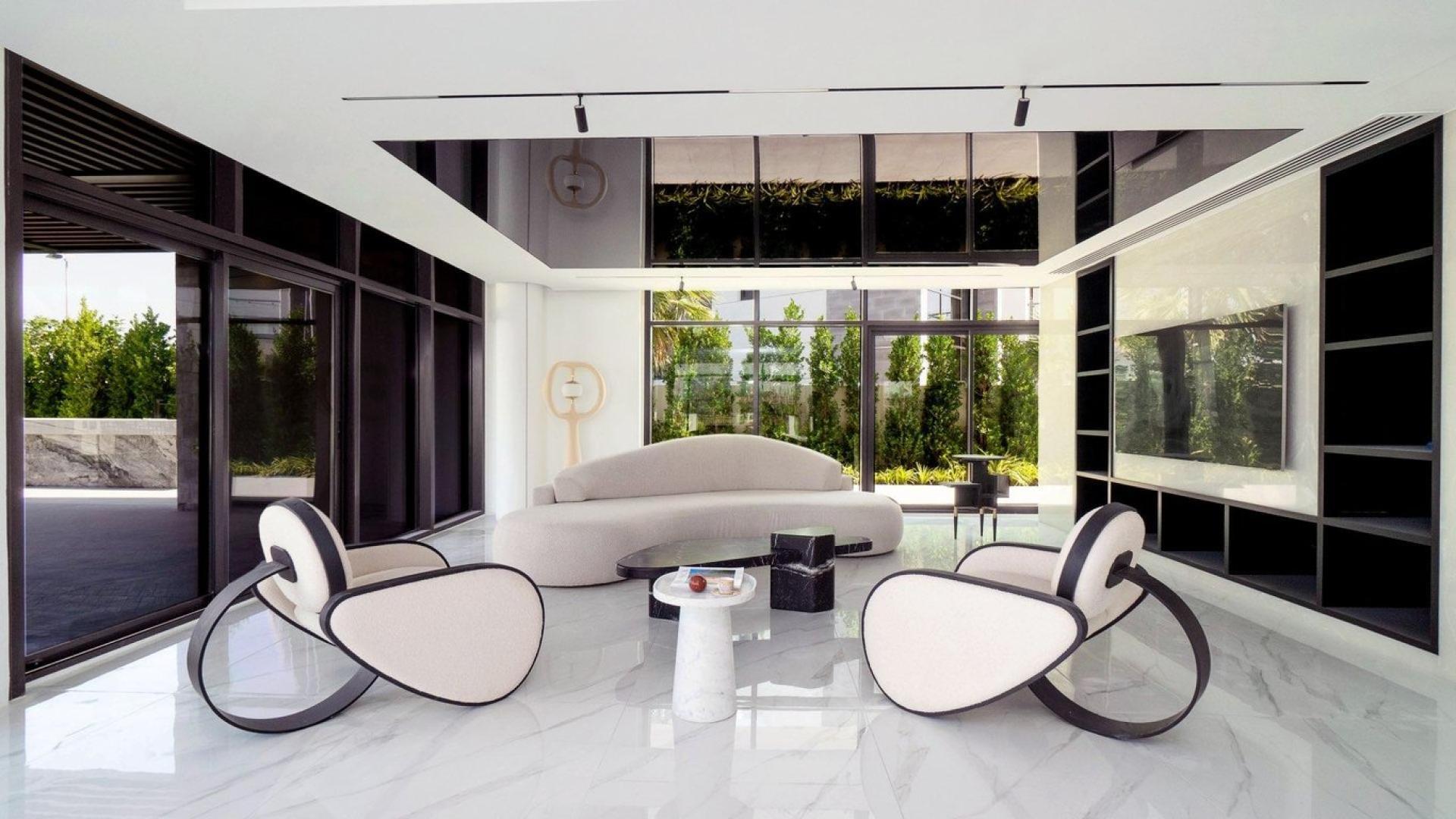 Exterior view of modern 6-bedroom villa in Damac Hills with golf course backdrop