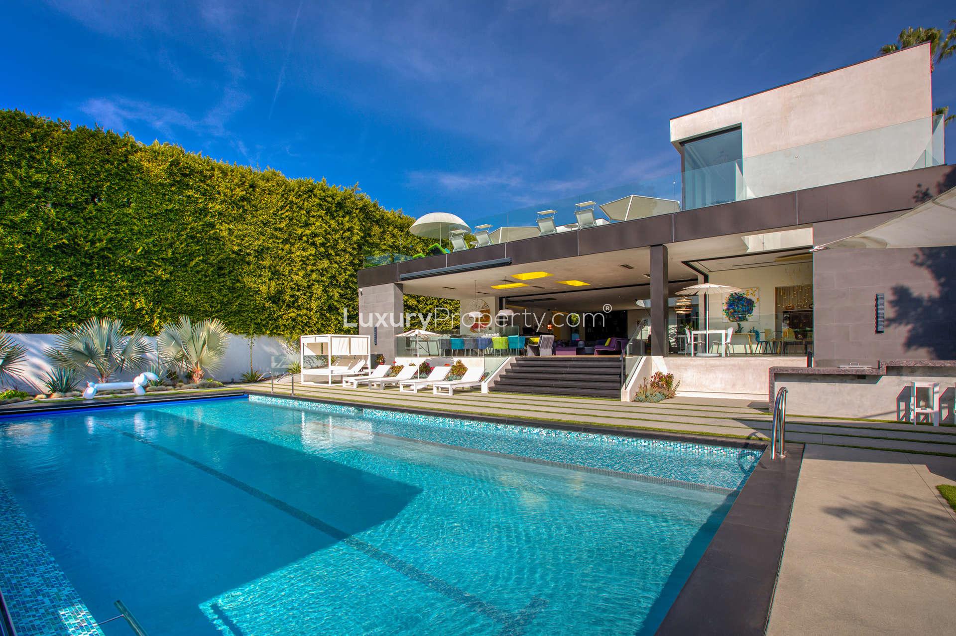 Contemporary Beverly Hills villa with pool, outdoor seating, and modern design for sale
