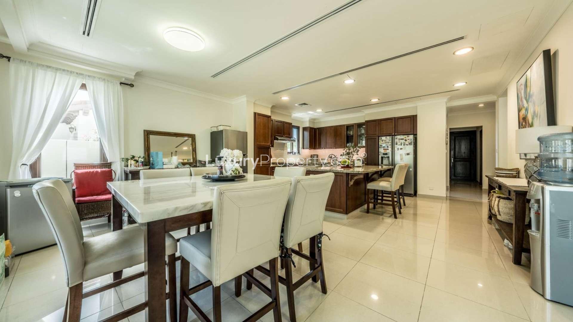 Luxury villa exterior in Arabian Ranches 2 Rosa, featuring double garage and lush landscaping