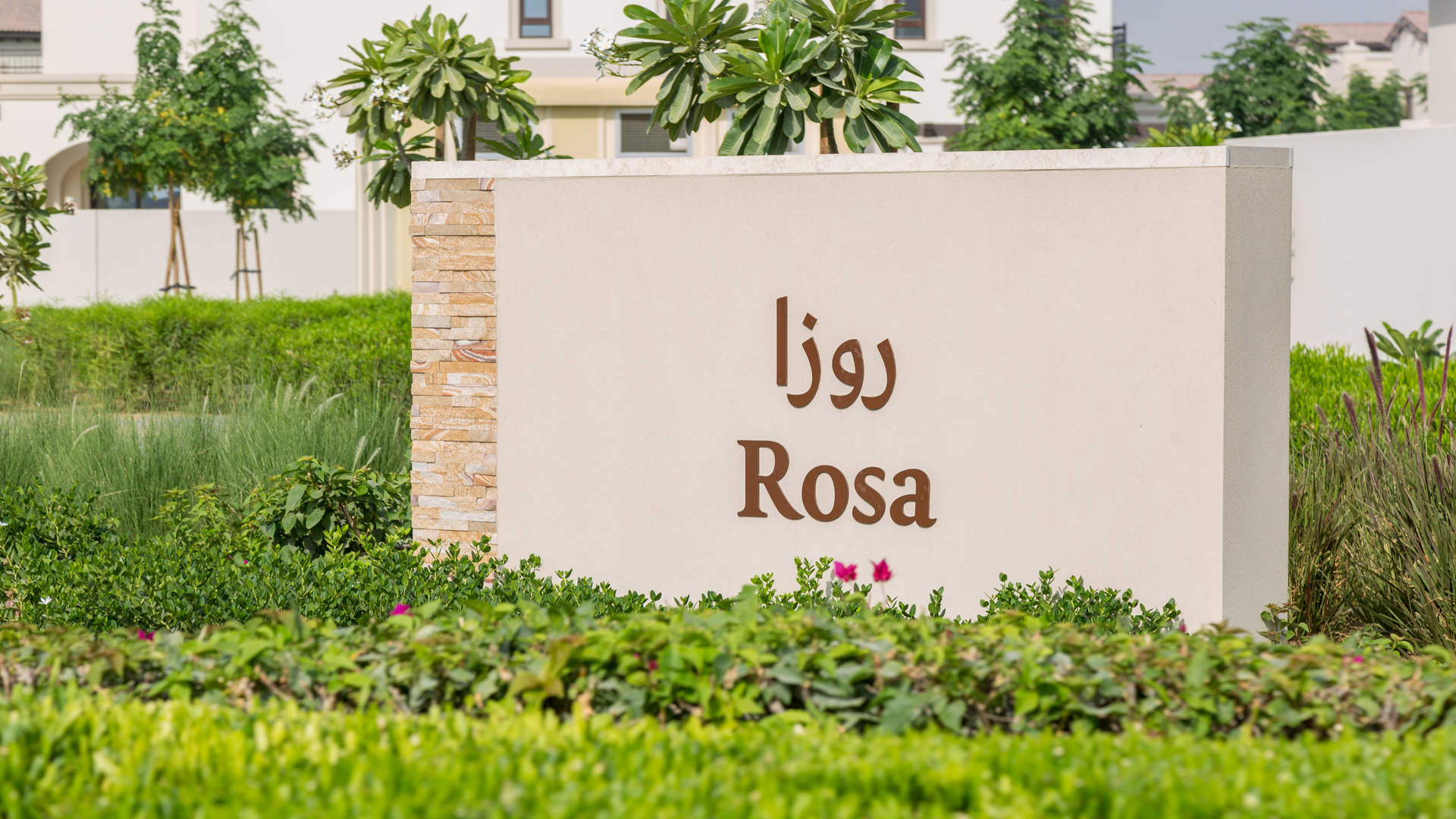 "Map of Rosa community layout in Arabian Ranches 2, showcasing villa plots and amenities.","Entrance sign of Rosa community in Arabian Ranches 2, surrounded by lush greenery.",Outdoor pool and play area at Spanish style villa in Arabian Ranches 2, Rosa community
