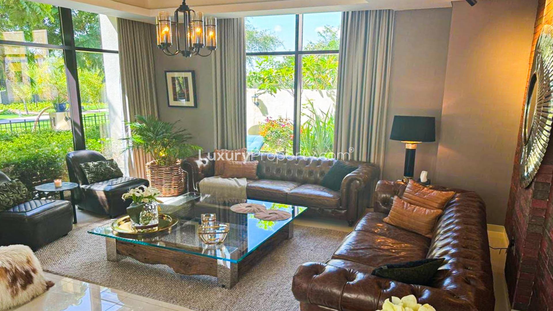Luxurious living room in Damac Hills villa with modern decor and large windows