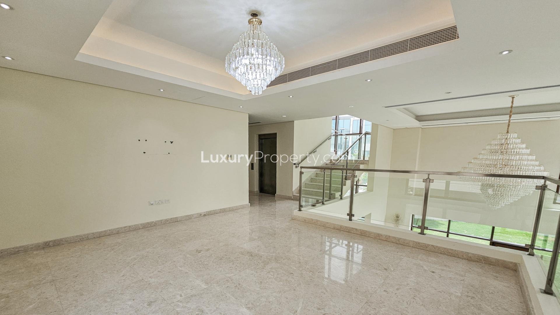 Spacious villa interior with large windows, chandeliers in Meydan Gated Community, Dubai