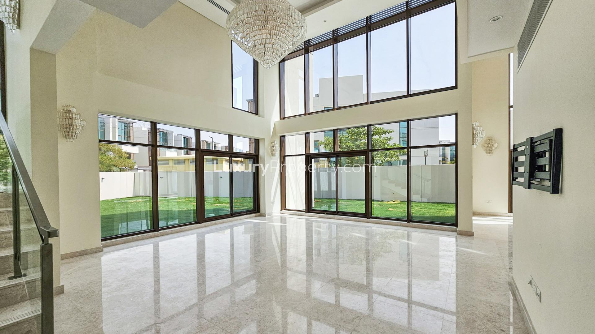 Gated Meydan villa with spacious lawn, modern architecture, and large windows for sale