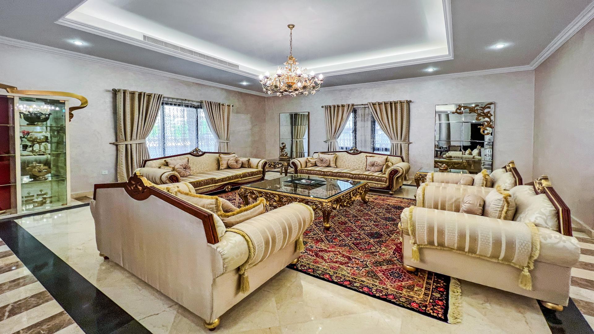 Luxurious living room in 6-bedroom Emirates Hills villa, Sector E, with modern decor