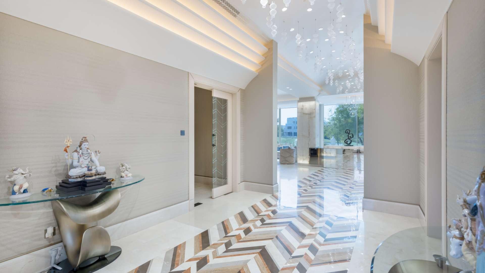 Spacious patio with garden view at 6-bedroom villa in Emirates Hills, Sector H