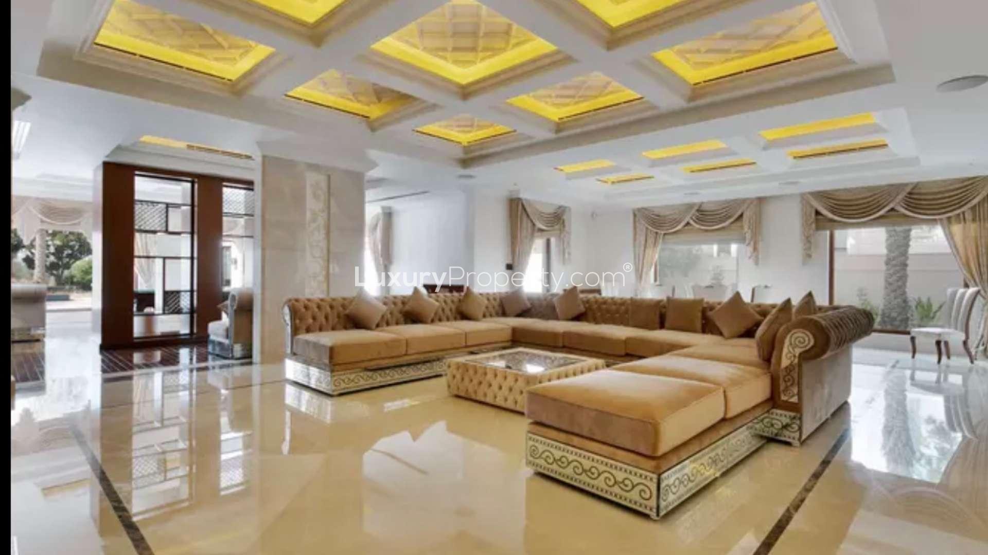 Luxurious entrance hall in 6-bedroom villa, Emirates Hills, featuring grand staircase and elegant decor