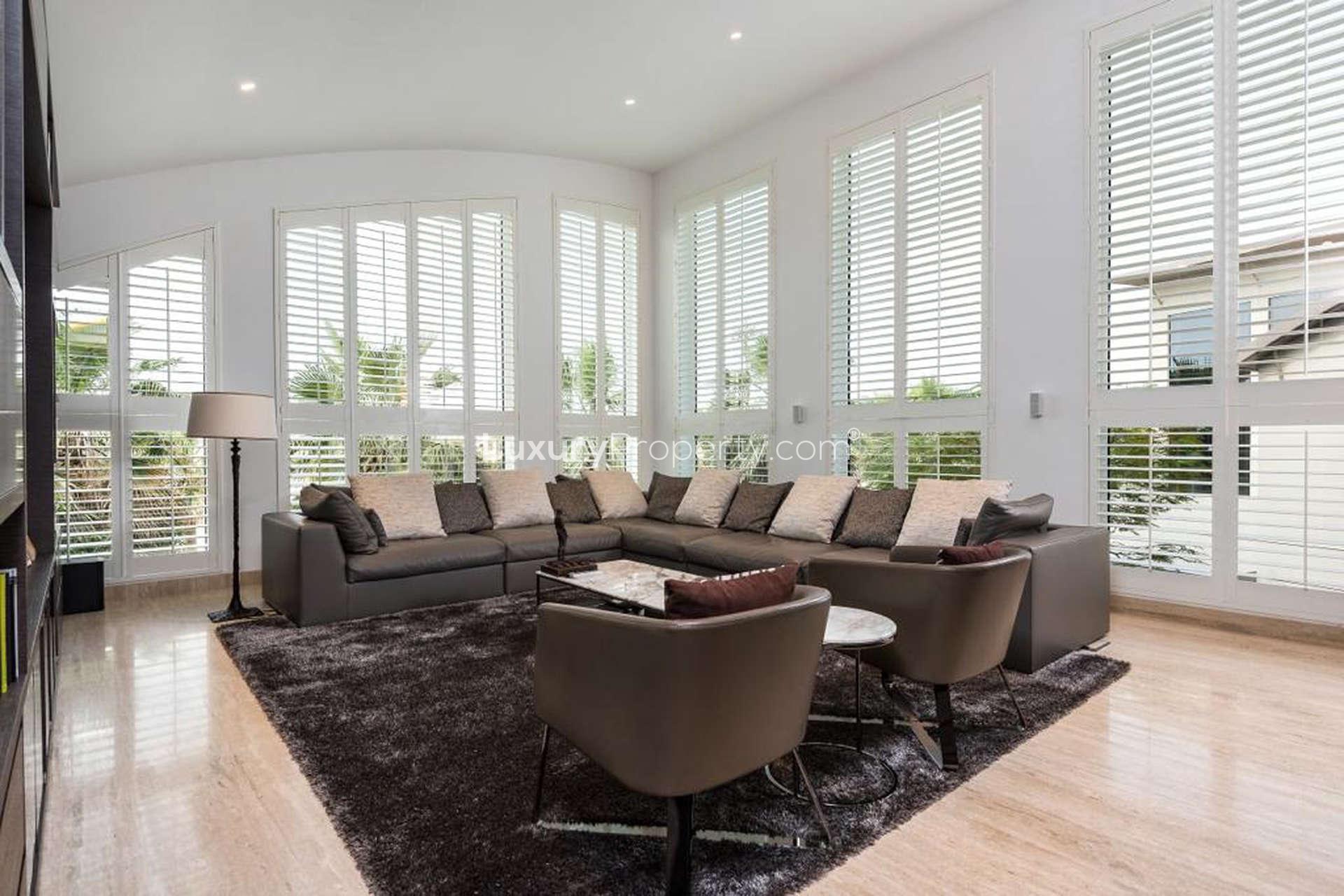 Luxurious living room in 6-bedroom villa, Palm Jumeirah, featuring elegant furnishings and large windows