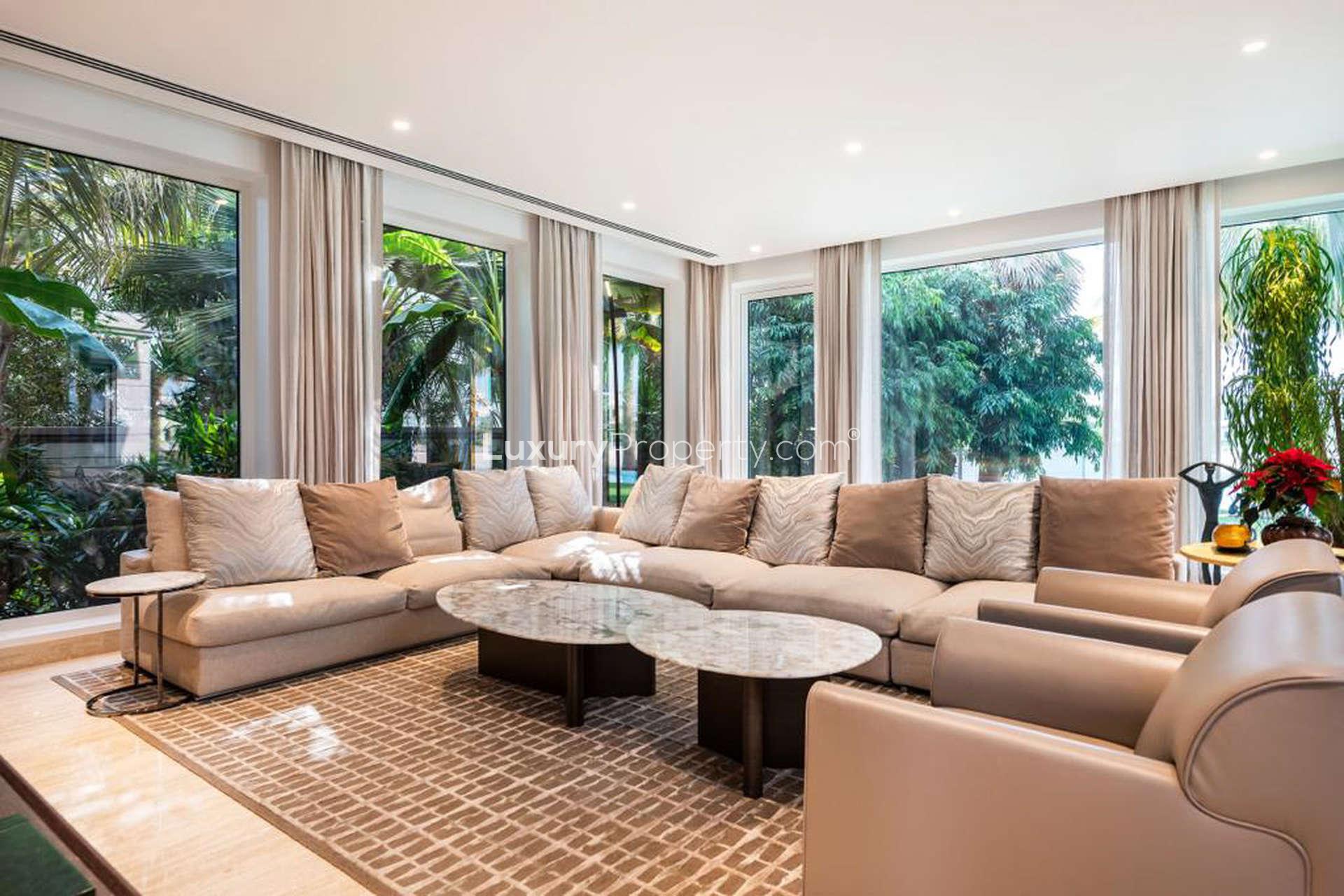Luxurious living room in 6-bedroom villa, Palm Jumeirah, featuring elegant furniture and garden views