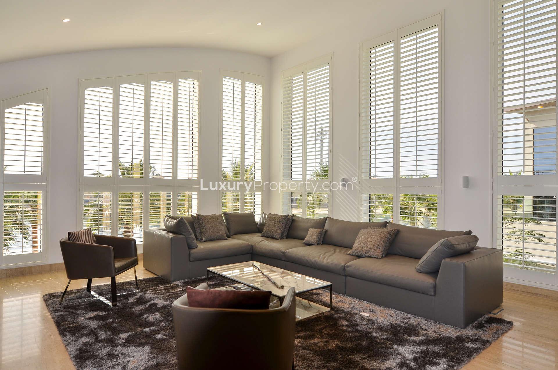 Luxurious living room in 6-bedroom Signature Villa, Palm Jumeirah, with modern decor and ample light