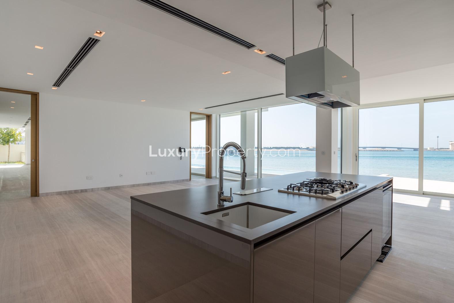 Spacious living area with floor-to-ceiling windows in Palm Jumeirah villa, sea views