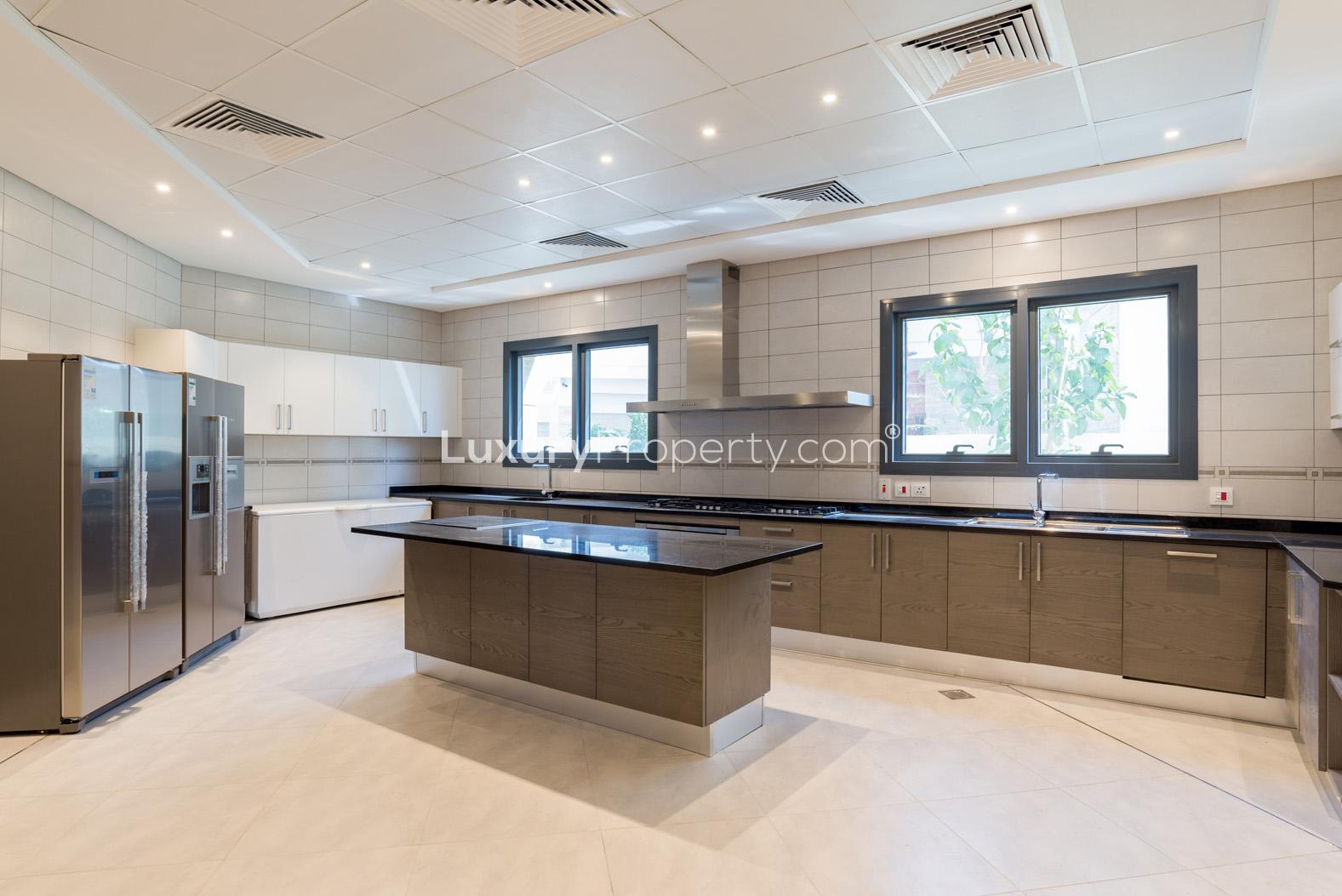 Modern kitchen in luxury 6-bedroom villa, Palm Jumeirah, with sleek appliances and island counter