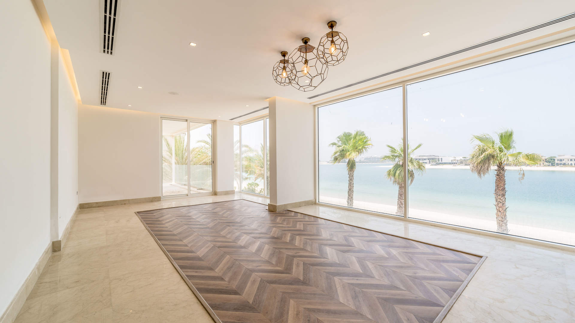 Luxury Palm Jumeirah villa kitchen with ocean view, modern fixtures, and infinity pool access